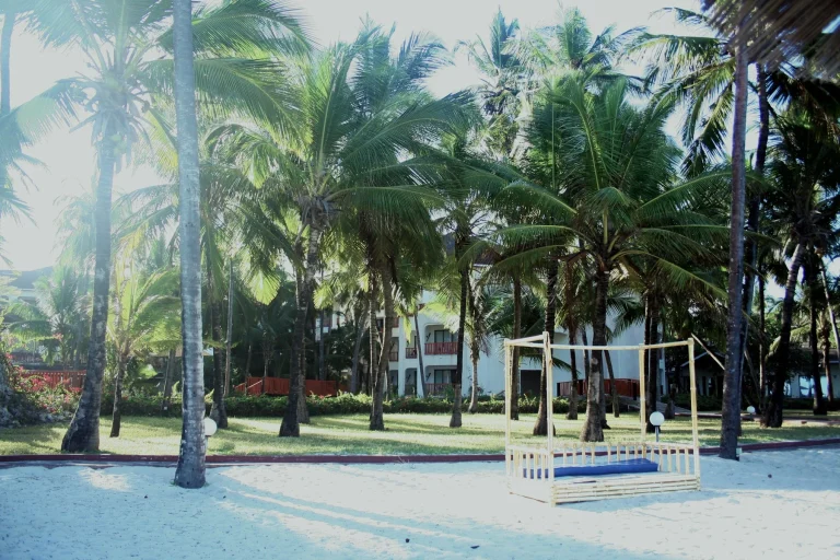 Visitors on a white sand beach near Mombasa, Kenya